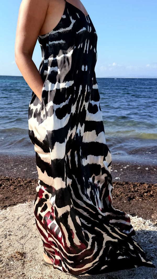 Amami Mariposa long silk resort dress worn by the sea

